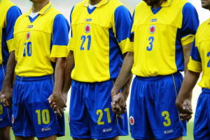 The Colombian players hold hands while observing the minutes silence in honour of Cameroon player Marc-Vivien Foe